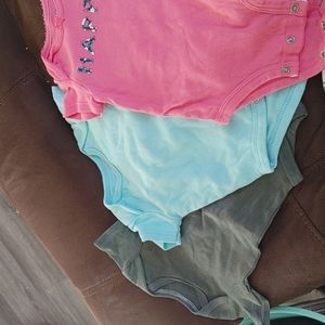 3 infant onesies in various colors